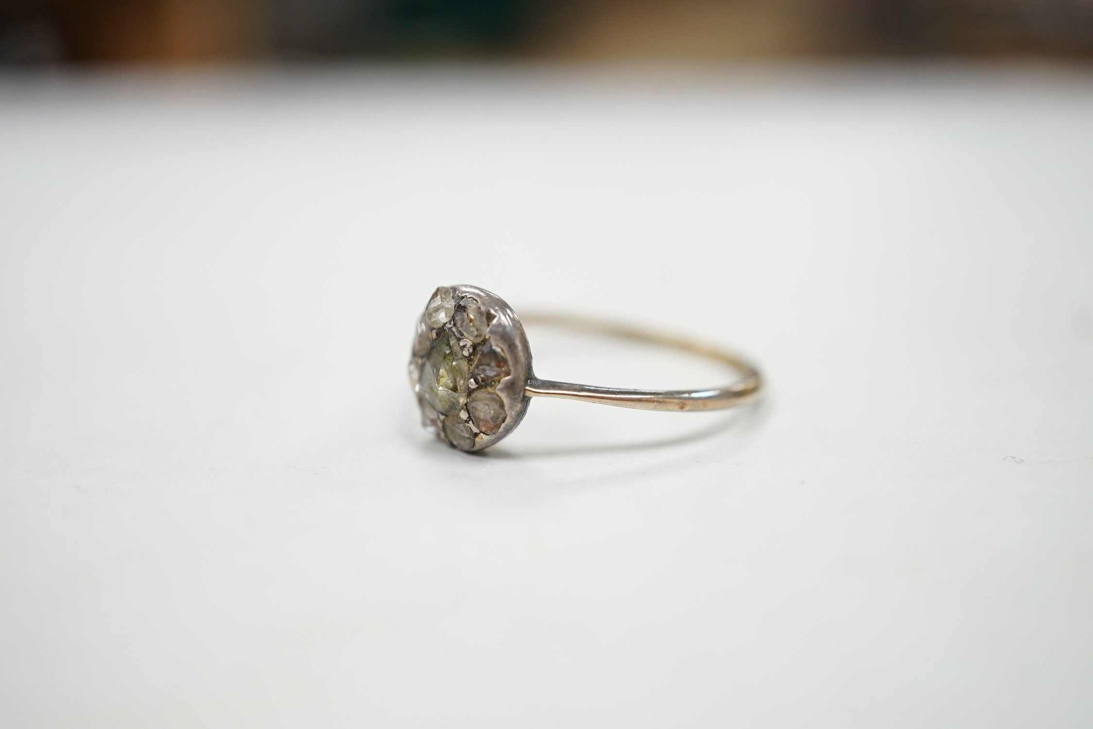 An antique yellow and white metal set rose cut diamond cluster ring, size S/T, gross weight 2.2 grams.